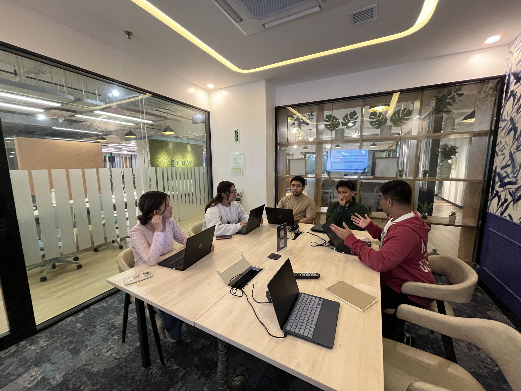 FutureTeamsPH engineers working together around a table at the Manila office